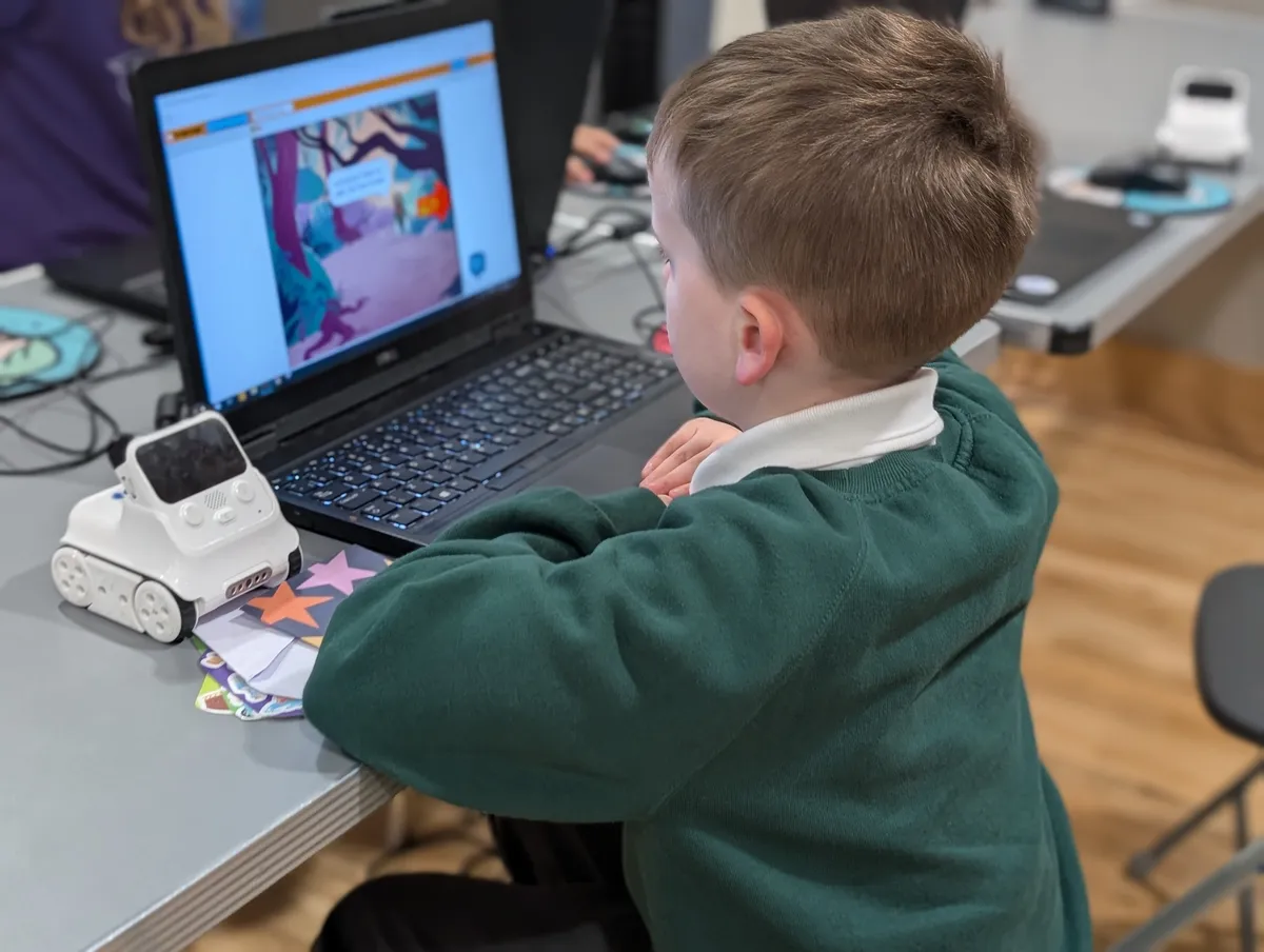 Child building a game at Cambridge
