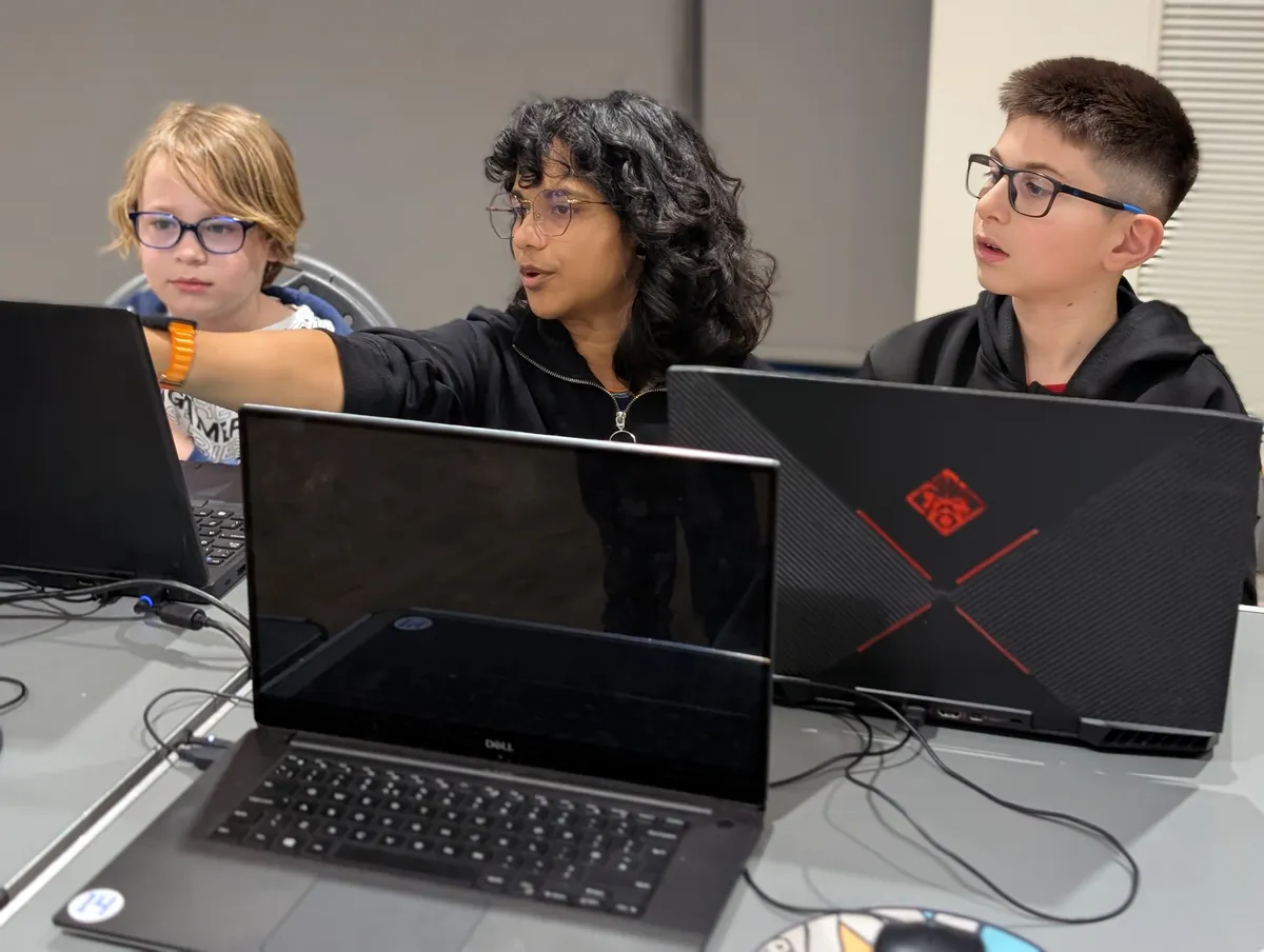 Mentor helping a child at Cambridge